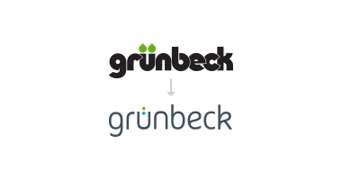 Zwei Logos mit dem Text "grünbeck"; oben schwarz mit grünen Akzenten, unten dunkelblau mit grünem Punkt über dem "ü", verbunden durch einen Pfeil nach unten.